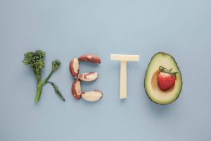 Keto word made from Ketogenic diet, low carb, healthy food on blue pastel background